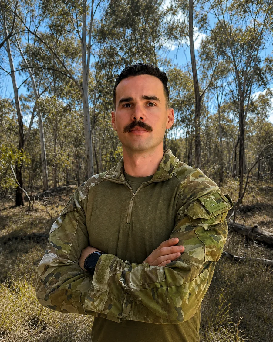 Taylor standing in Australian bushland in Army field uniform