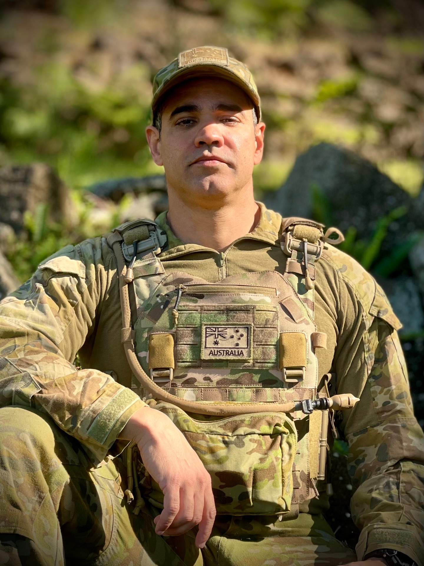 Tulio Lima seated outdoors in Australian Army field uniform